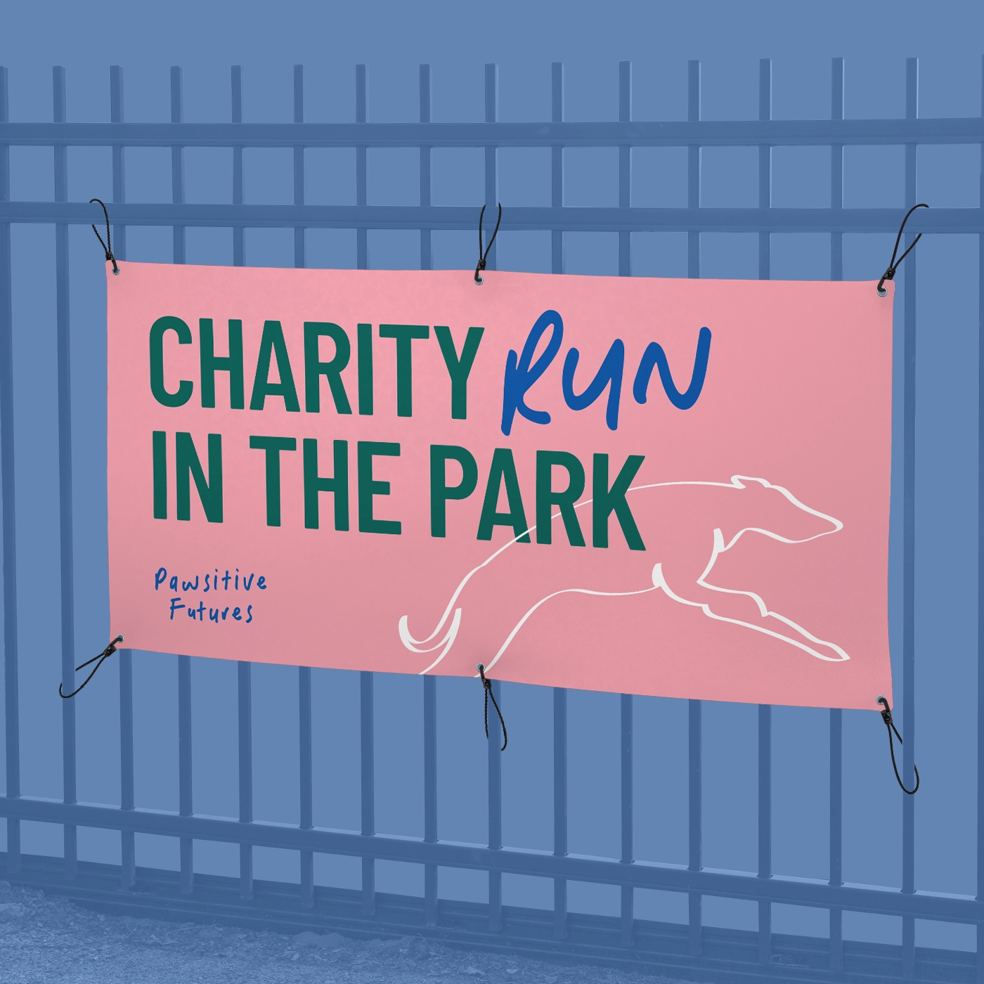 Pink Banner with eyelets hung on a fence for a "Charity Run in the Park".