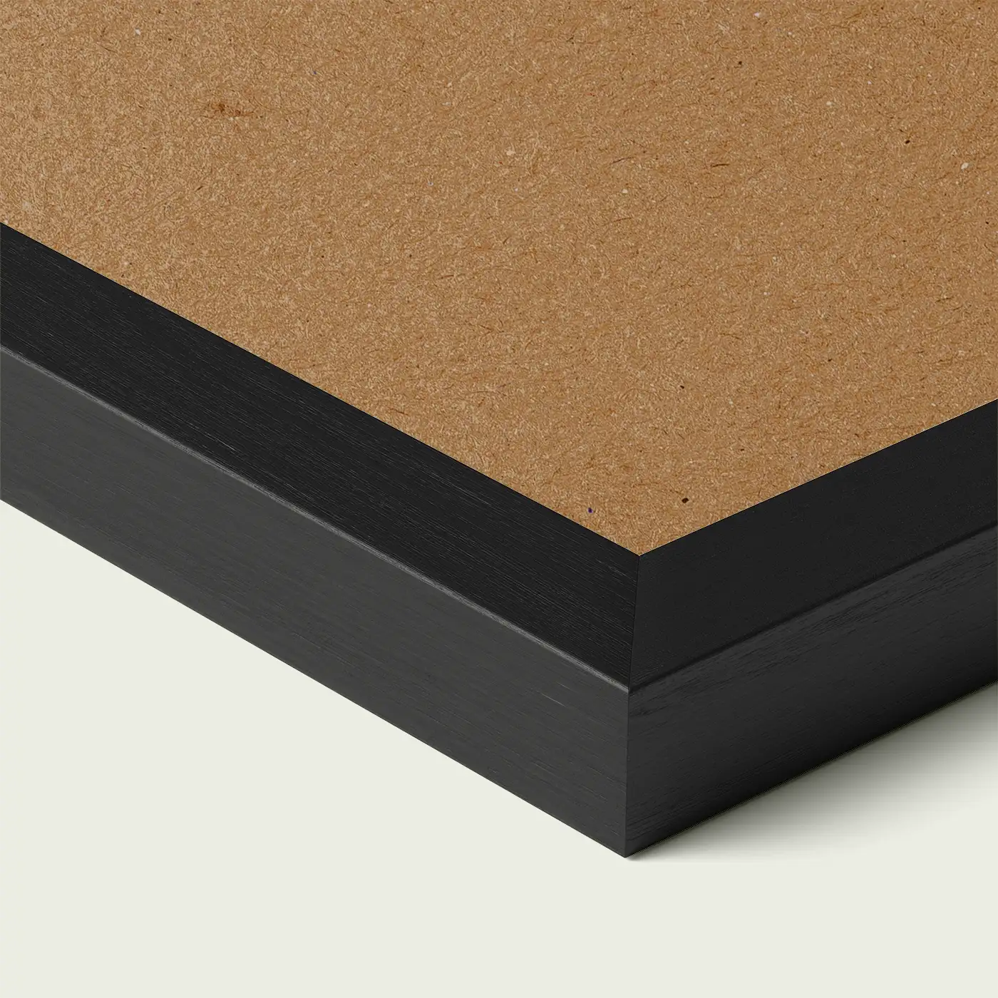 Close-up of a black picture frame corner with smooth painted edge and wooden backing, shown against a light neutral background