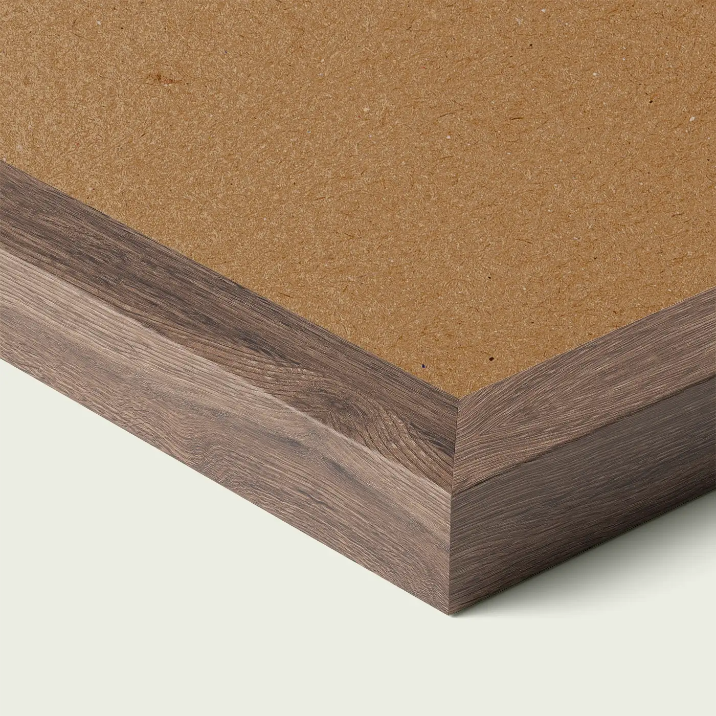 Close-up of a brown grain picture frame corner with smooth painted edge and wooden backing, shown against a light neutral background