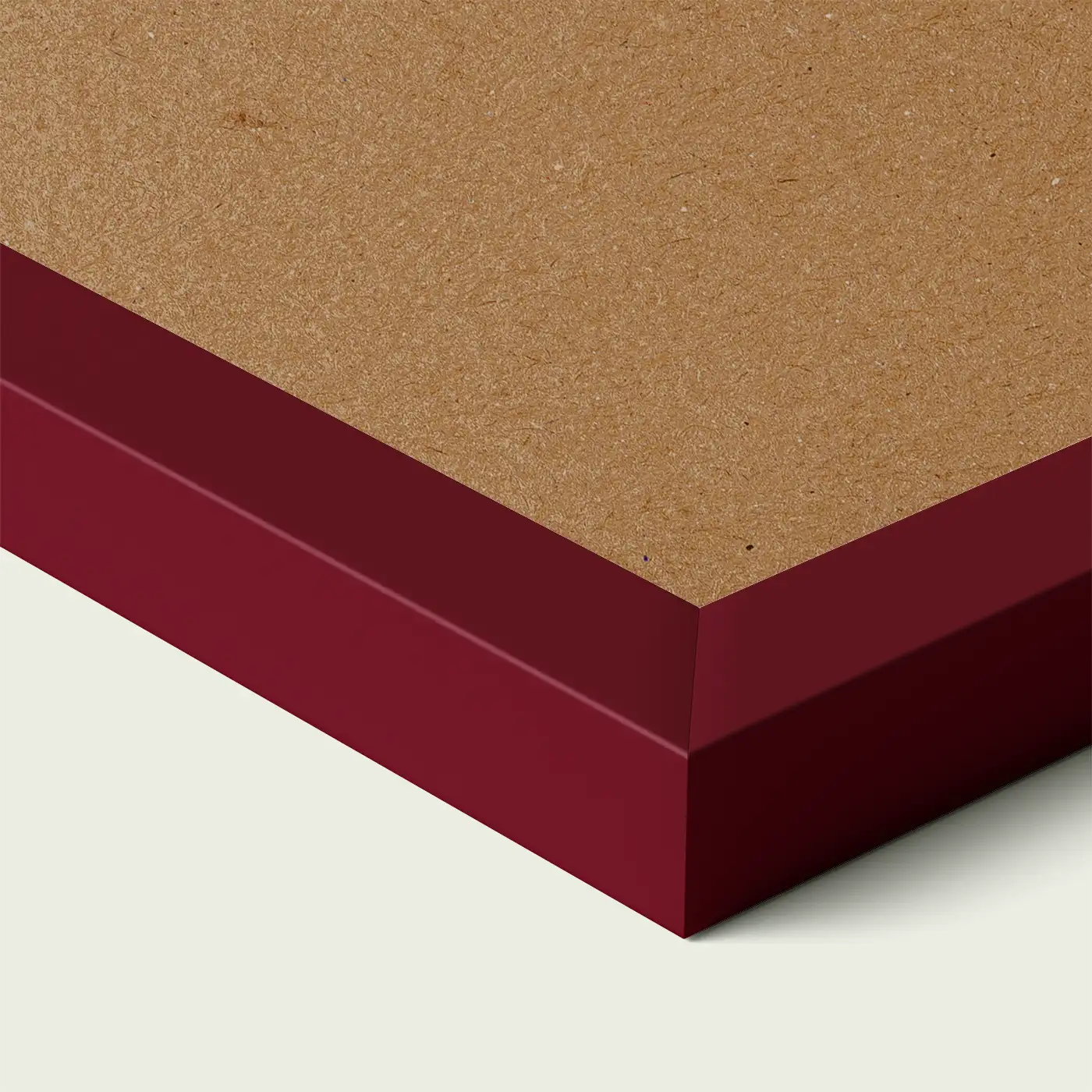 Close-up of a burgundy picture frame corner with smooth painted edge and wooden backing, shown against a light neutral background