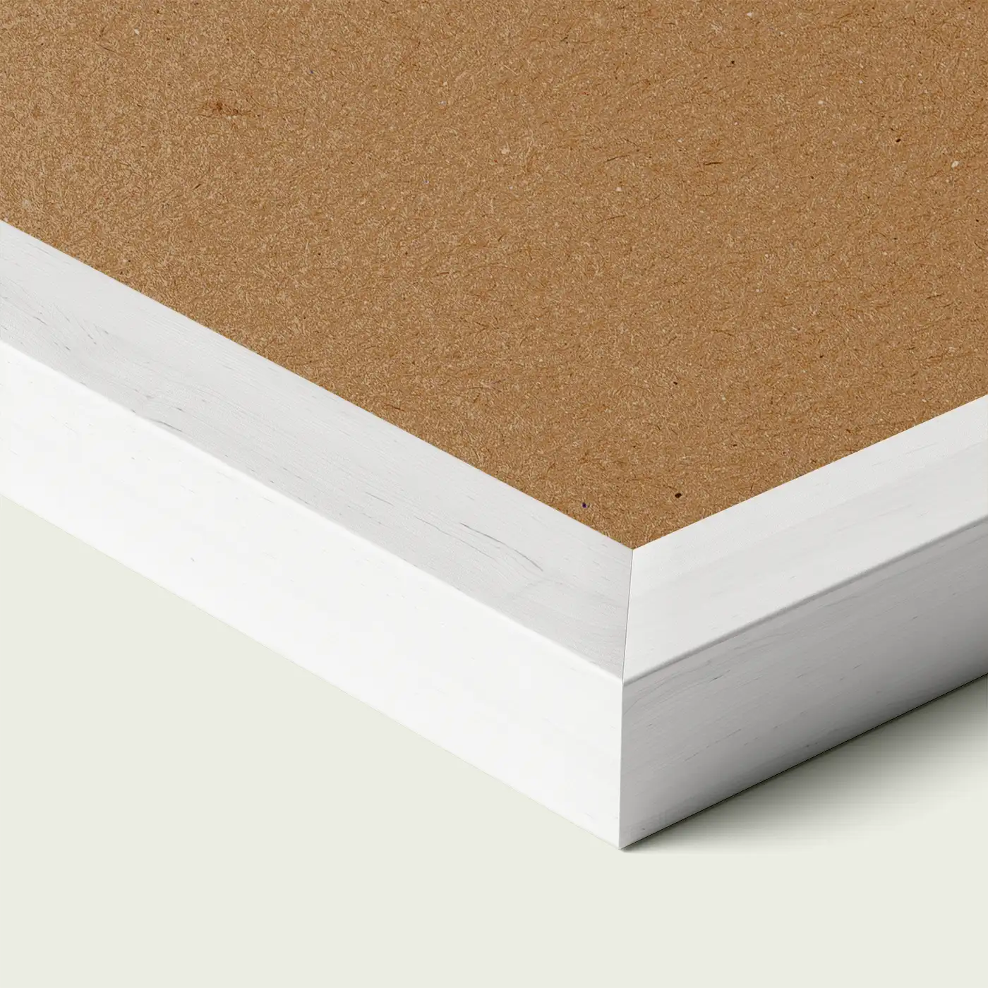 Close-up of a white picture frame corner with smooth painted edge and wooden backing, shown against a light neutral background