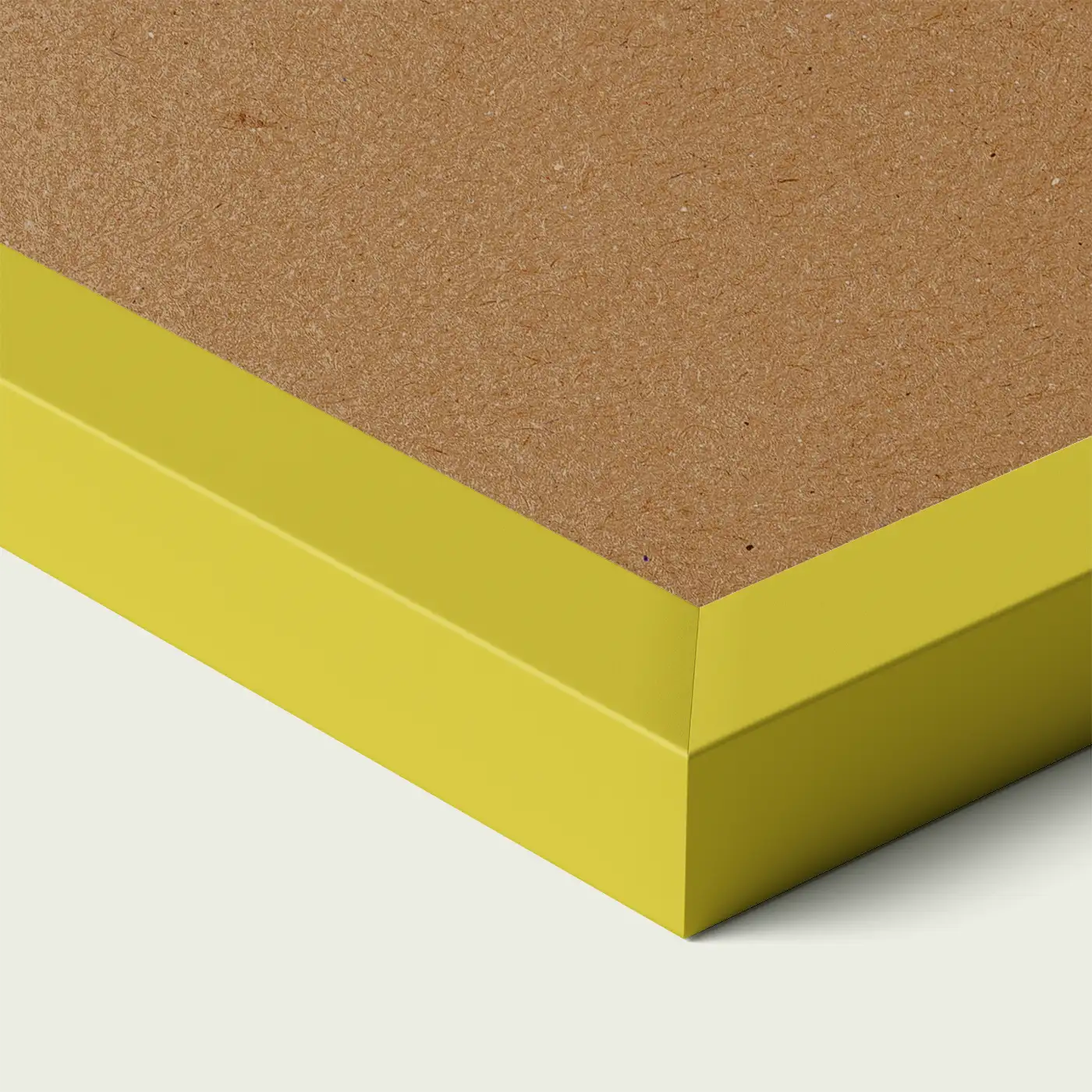 Close-up of a yellow picture frame corner with smooth painted edge and wooden backing, shown against a light neutral background