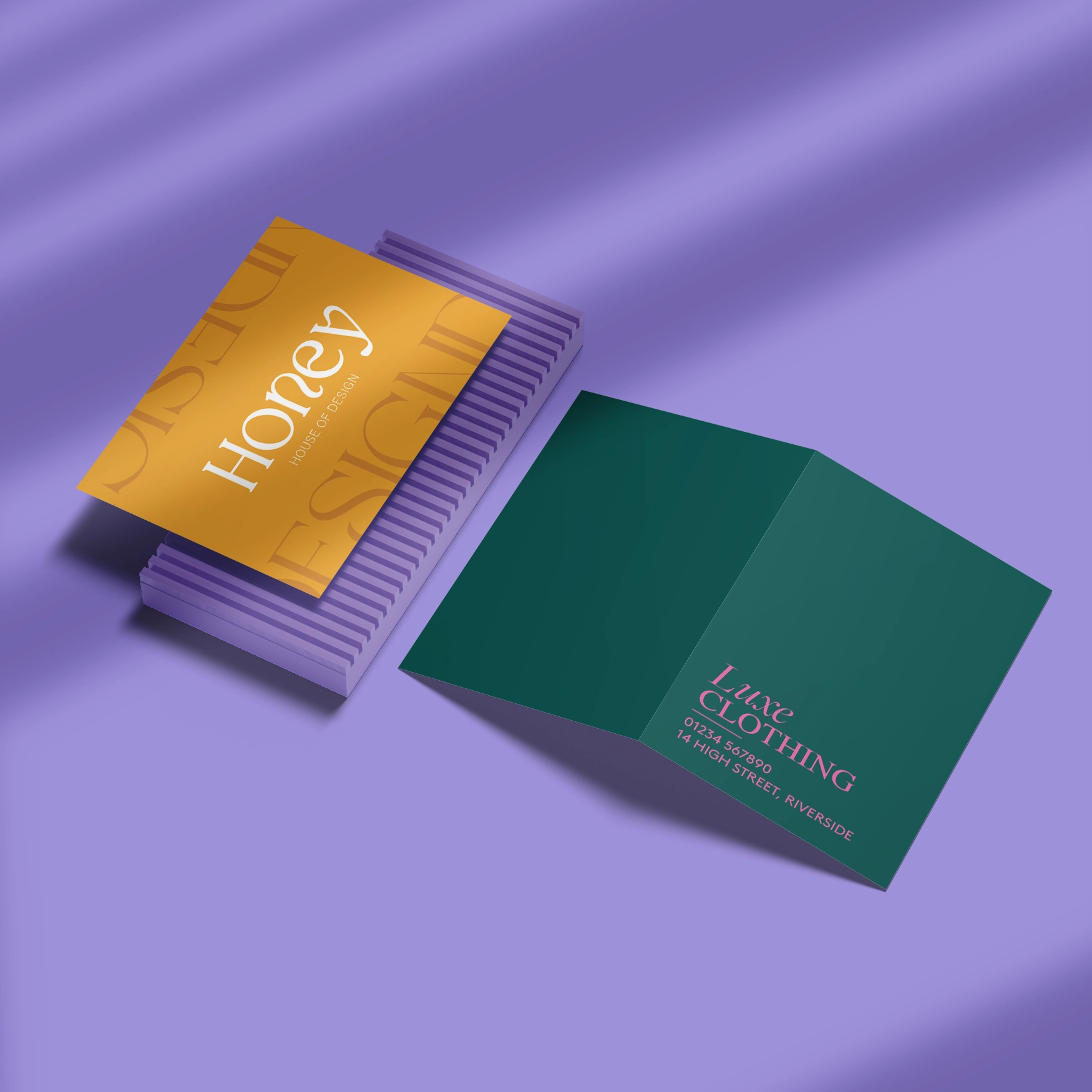Two Business Cards on a purple background, one in a flat format with a yellow design and the text "Honey", the other in a folded format in a dark green design with pink text.