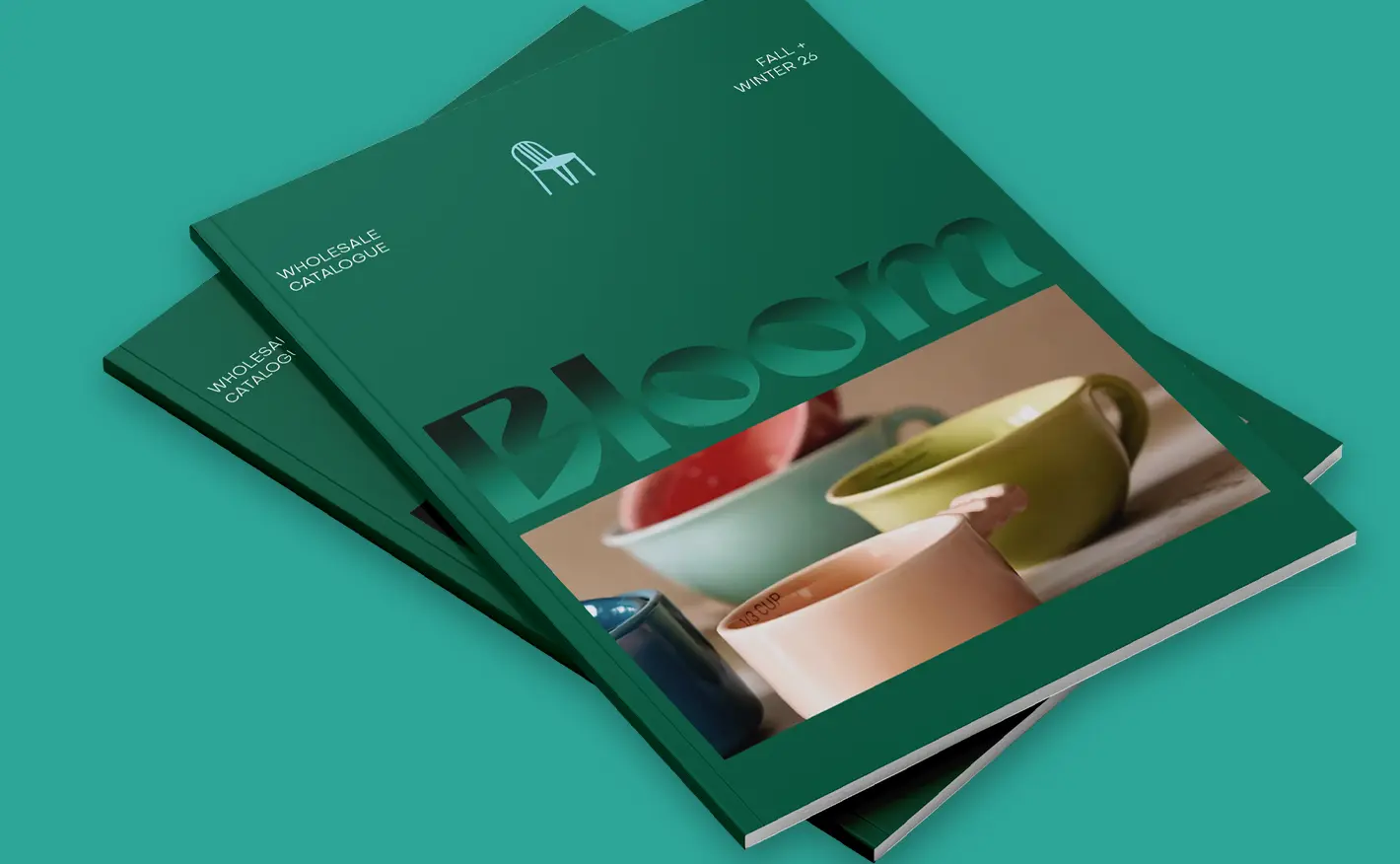 Stacked green wholesale Booklets titled “Bloom,” featuring glossy spot UV text and a photo of colourful ceramic cups