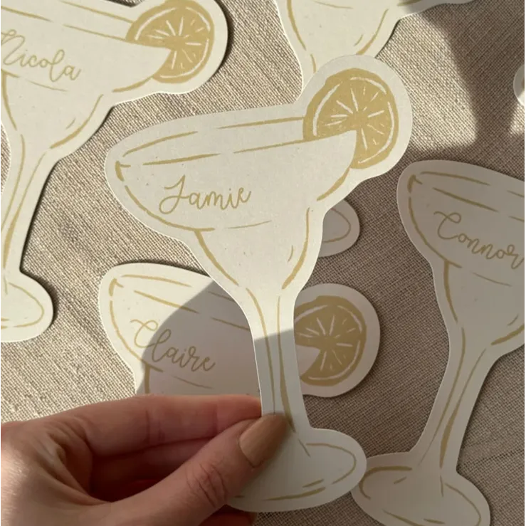 Cocktail glass-shaped Wedding Place Cards with lemon slice accents and handwritten names