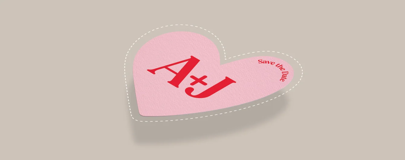 A pink heart-shaped print with bold “A + J” text and a small “save the date” note