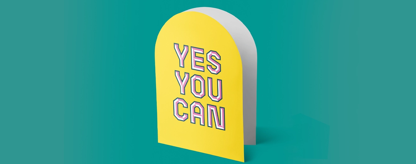 Upper arch-shaped, bright yellow Greeting Card, featuring bold pink-and-white text that reads 'YES YOU CAN'.'