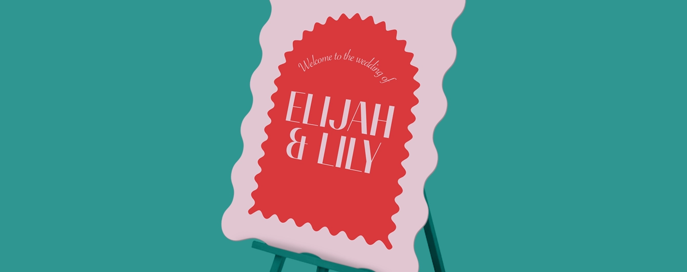 Wavy-shaped Wedding Welcome Sign on an easel with a pink border and red centre, White text reads “Welcome to the wedding of ELIJAH & LILY".