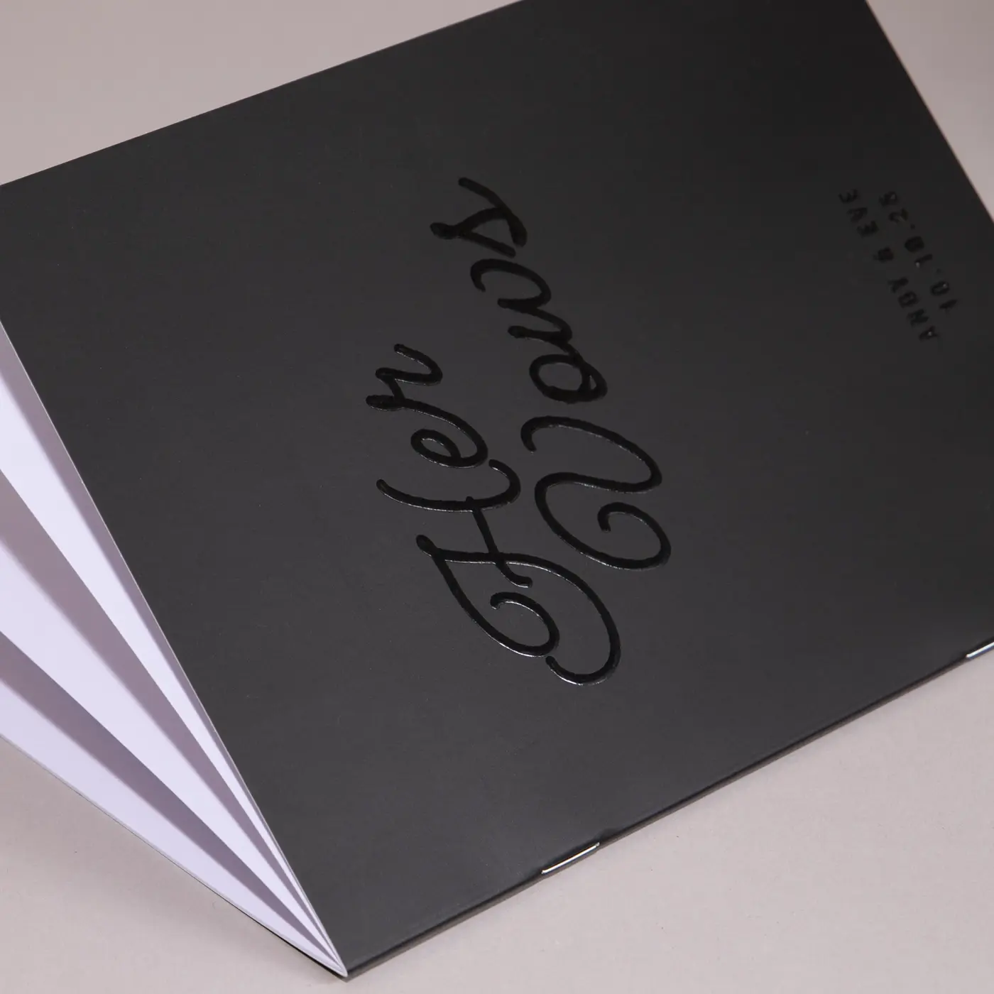 Black wedding vow booklet with “Her Vows” in elegant spot UV script