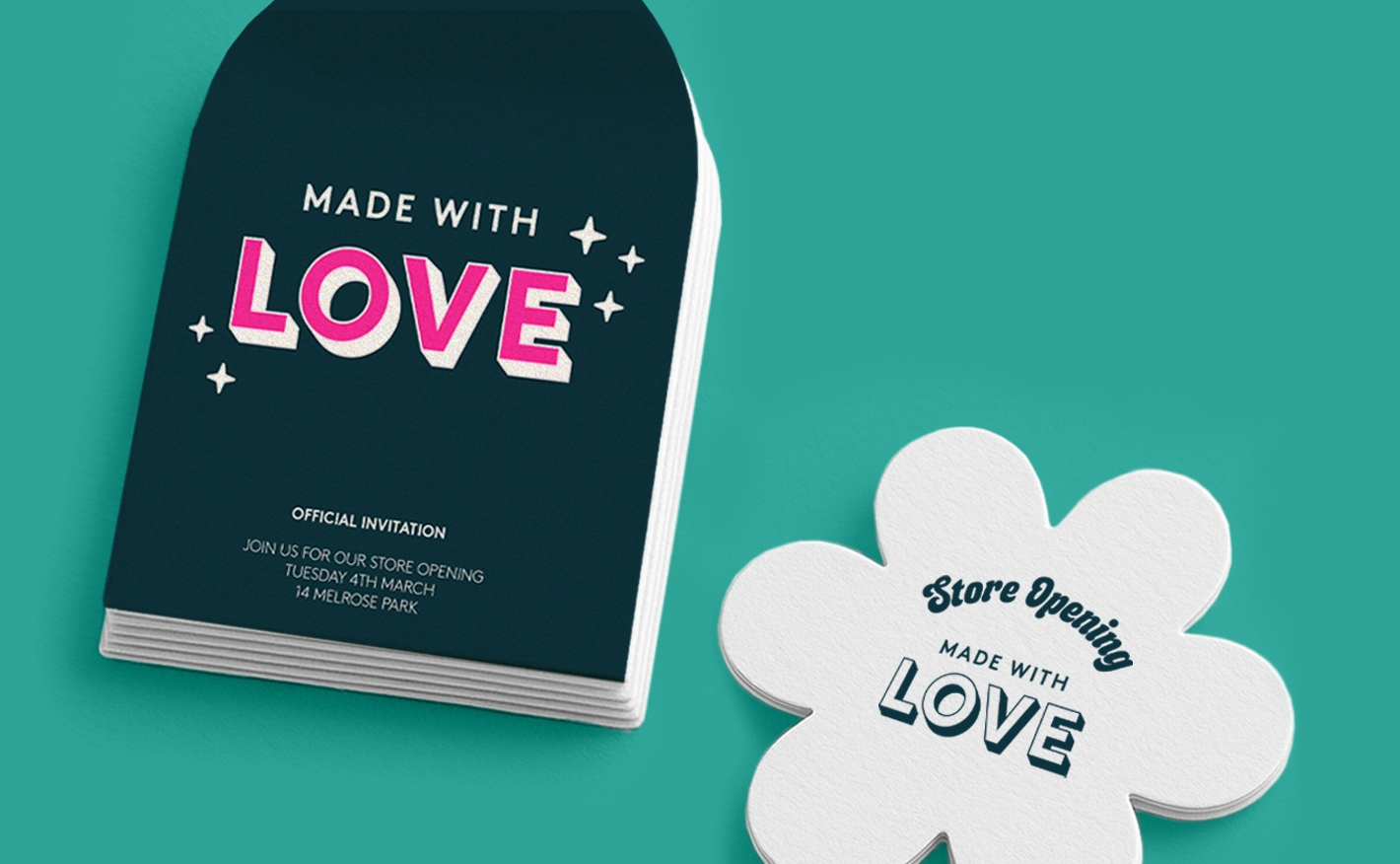 An arch shape dark blue invitation reading "MADE WITH LOVE" beside a flower shaped store opening Postcard with a white background and blue text.