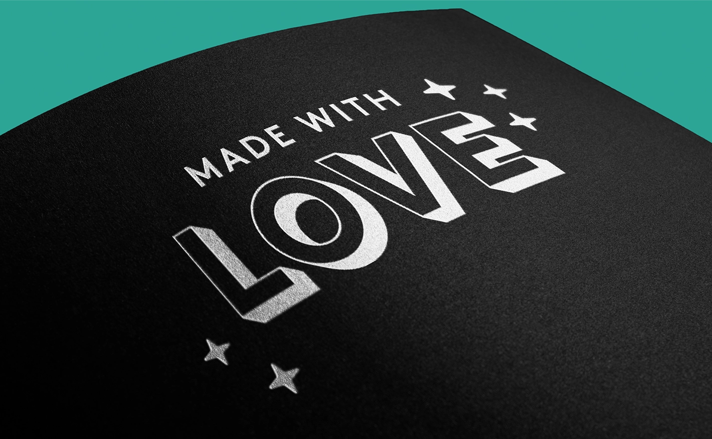 White ink printed text reading "MADE WITH LOVE" on a black paper background.