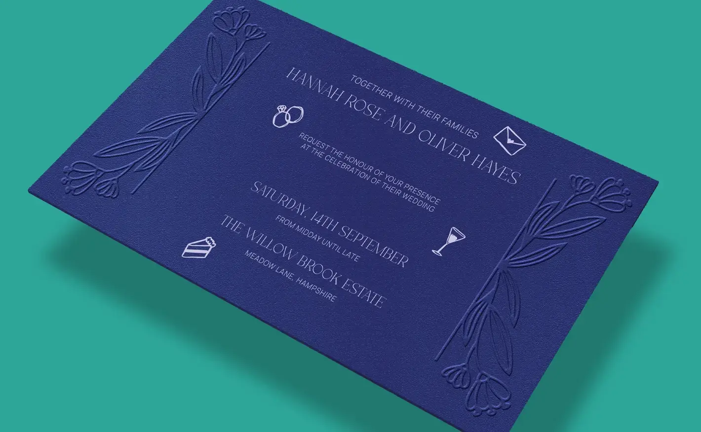 Dark blue Wedding Invitation featuring raised, embossed floral detailing along both edges, with light text announcing the wedding of Hannah Rose and Oliver Hayes