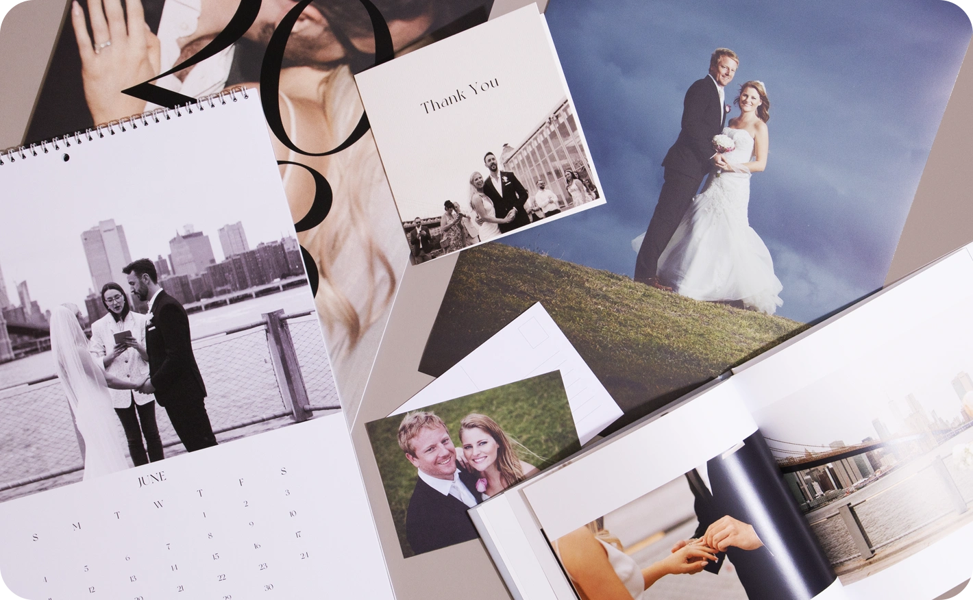 A collection of wedding photo products, including a Calendar, Thank You Card, Photo Book, and loose prints featuring a couple