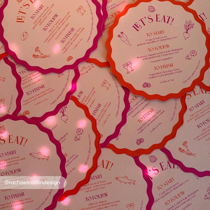 Wavy circle Wedding Menus with red and purple borders, titled ‘Let’s Eat!’, showing a three‑course food menu with small illustrated food icons