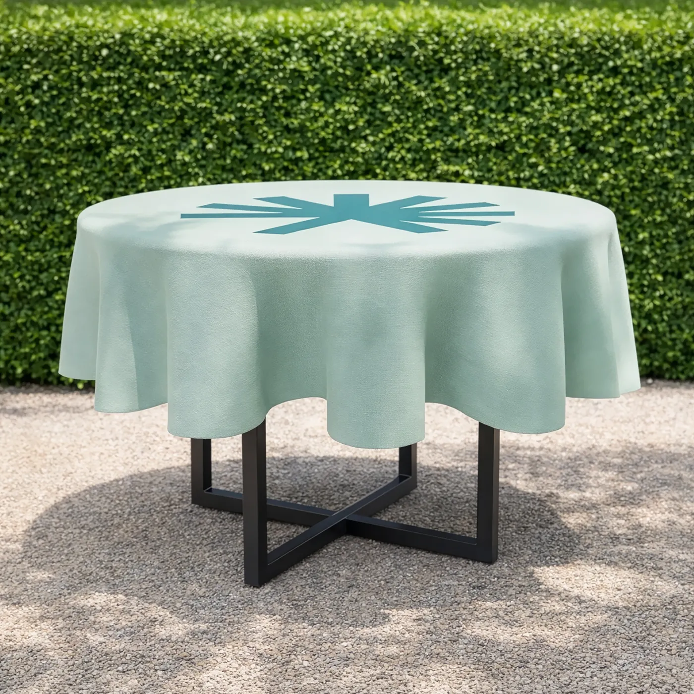 Round Tablecloth on a modern outdoor table set against a neat garden backdrop.