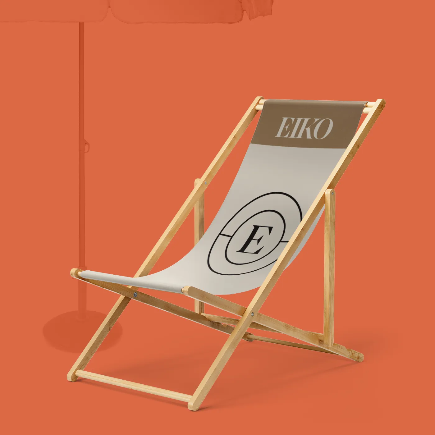 Branded deck chair against an orange backdrop, featuring a simple logo and clean, modern design.