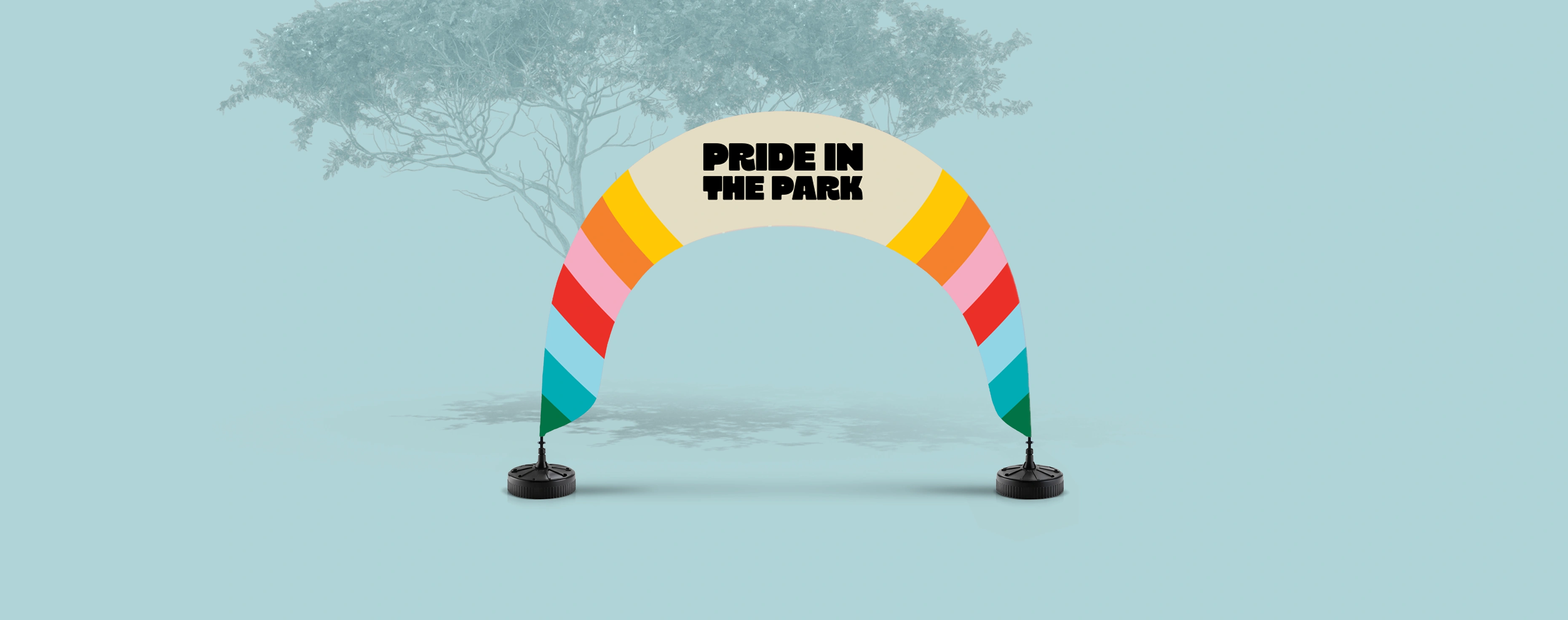 Colourful arch flag on a light backdrop for a pride‑themed event.