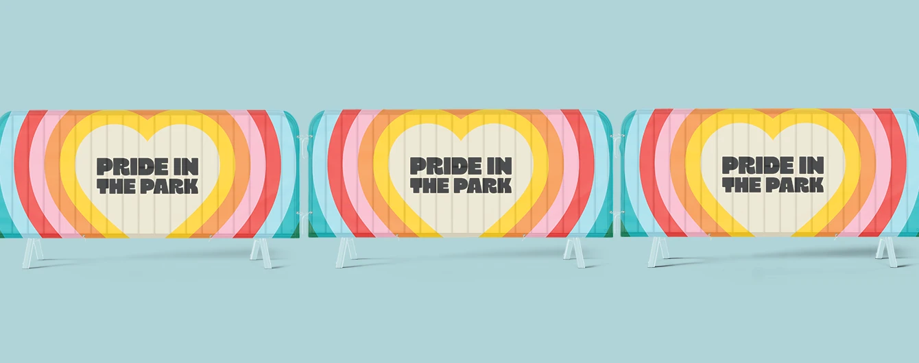 Colourful crowd barrier covers displayed side by side on a light backdrop for a pride‑themed event.