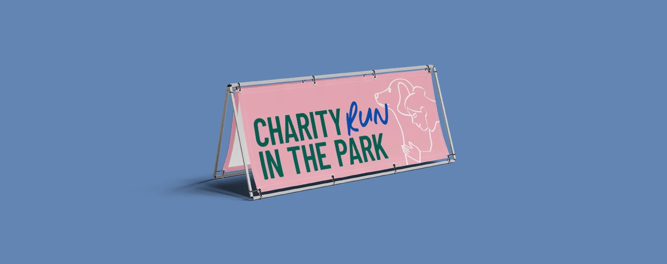Outdoor a frame banner on a blue backdrop promoting a charity event.