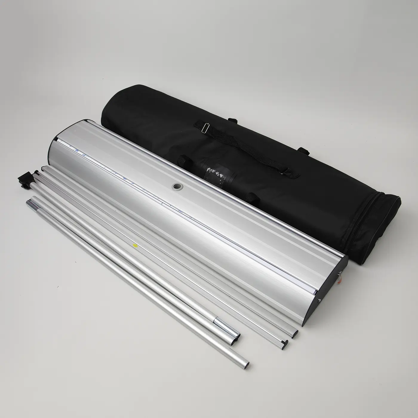 Double Sided Roller Banner silver base laid out with disassembled support poles and a black padded carry bag.