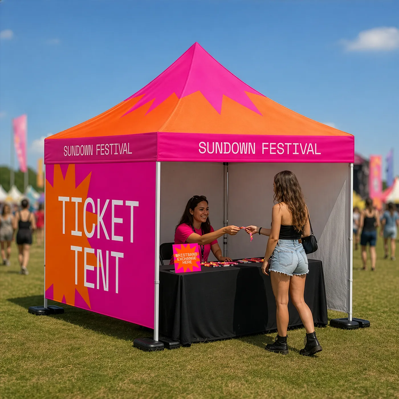 A Deluxe Gazebo for "Sundown Festival," featuring a vibrant pink and orange starburst design and a side wall labeled "TICKET TENT."