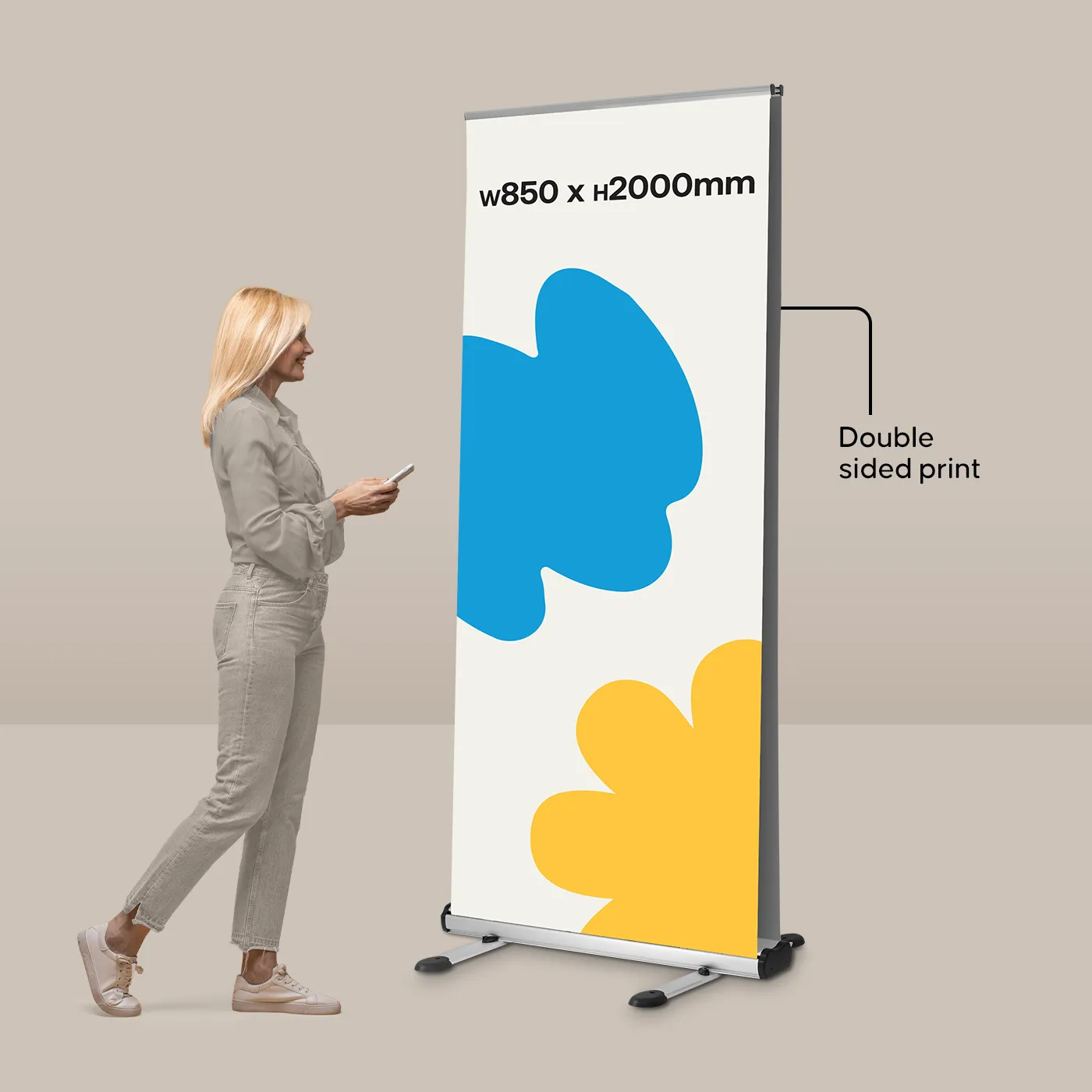 An 850mm wide double-sided Outdoor Roller Banner shown next to a person to illustrate its 2m height and scale.