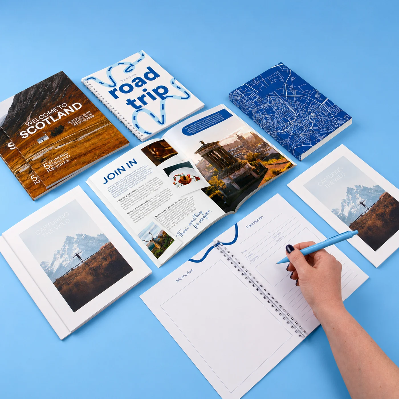 An arrangement of travel Journals, in a range of spiral and perfect bound styles.
