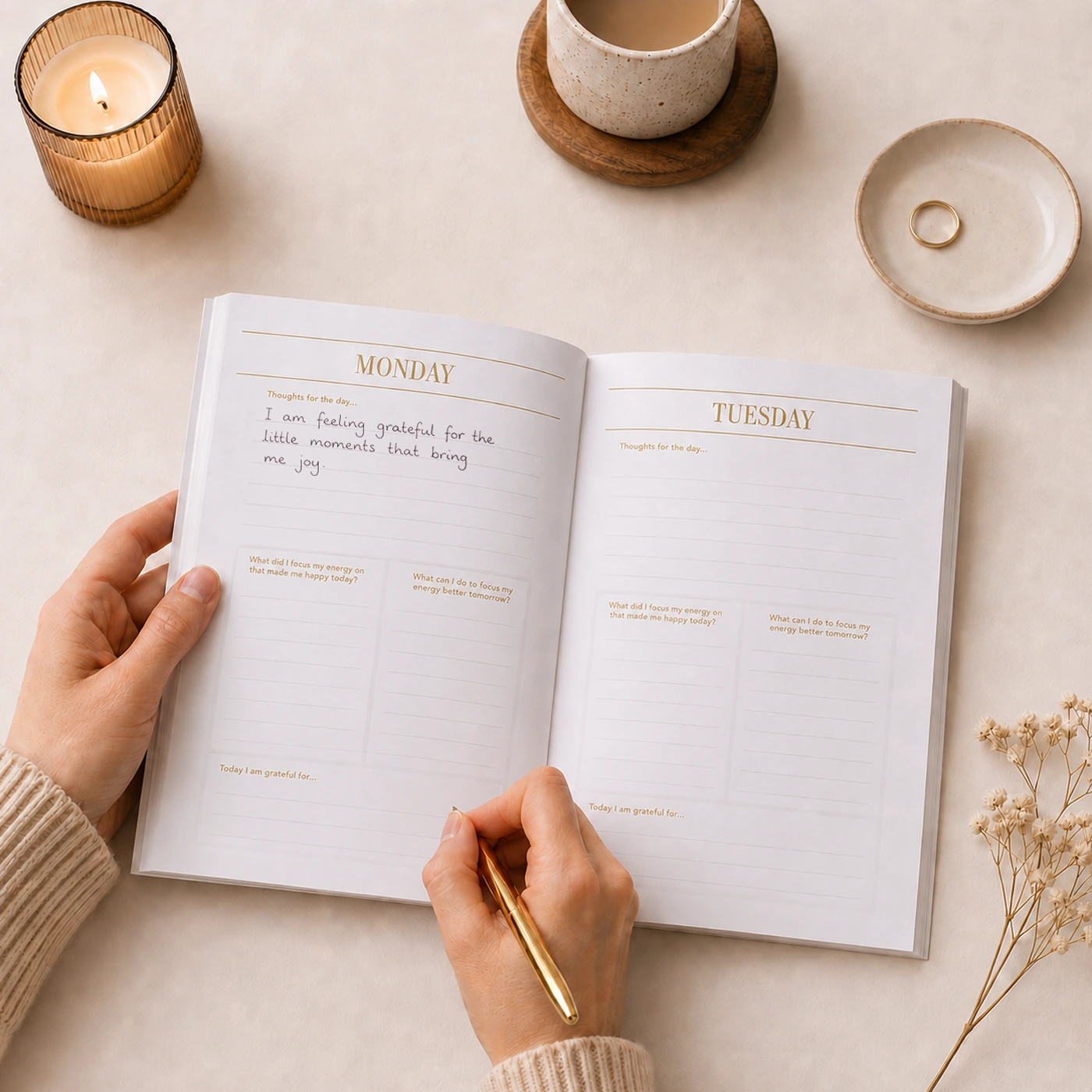 A Perfect Bound Journal laid open with someone writing daily affirmations.