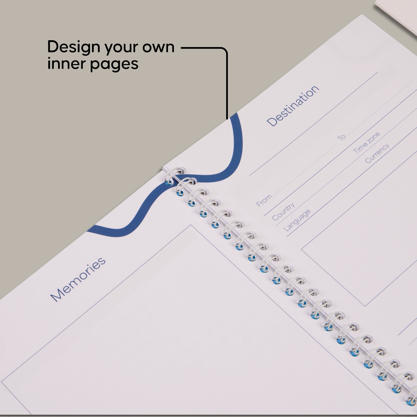 An open Spiral Bound Journal with a travel-themed layout, highlighting the text "Design your own inner pages."