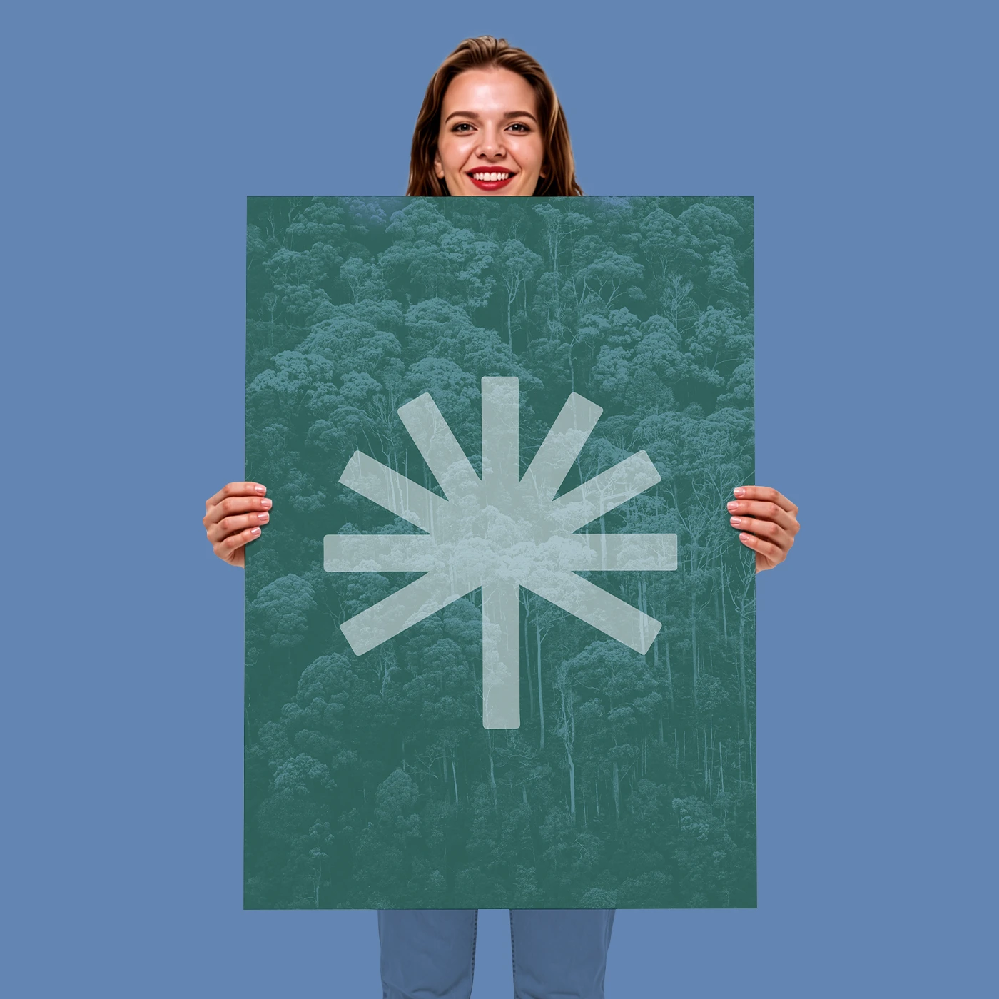 A person holding a green A1 Poster featuring a light green, ten-pointed star-like symbol over a background pattern of trees.