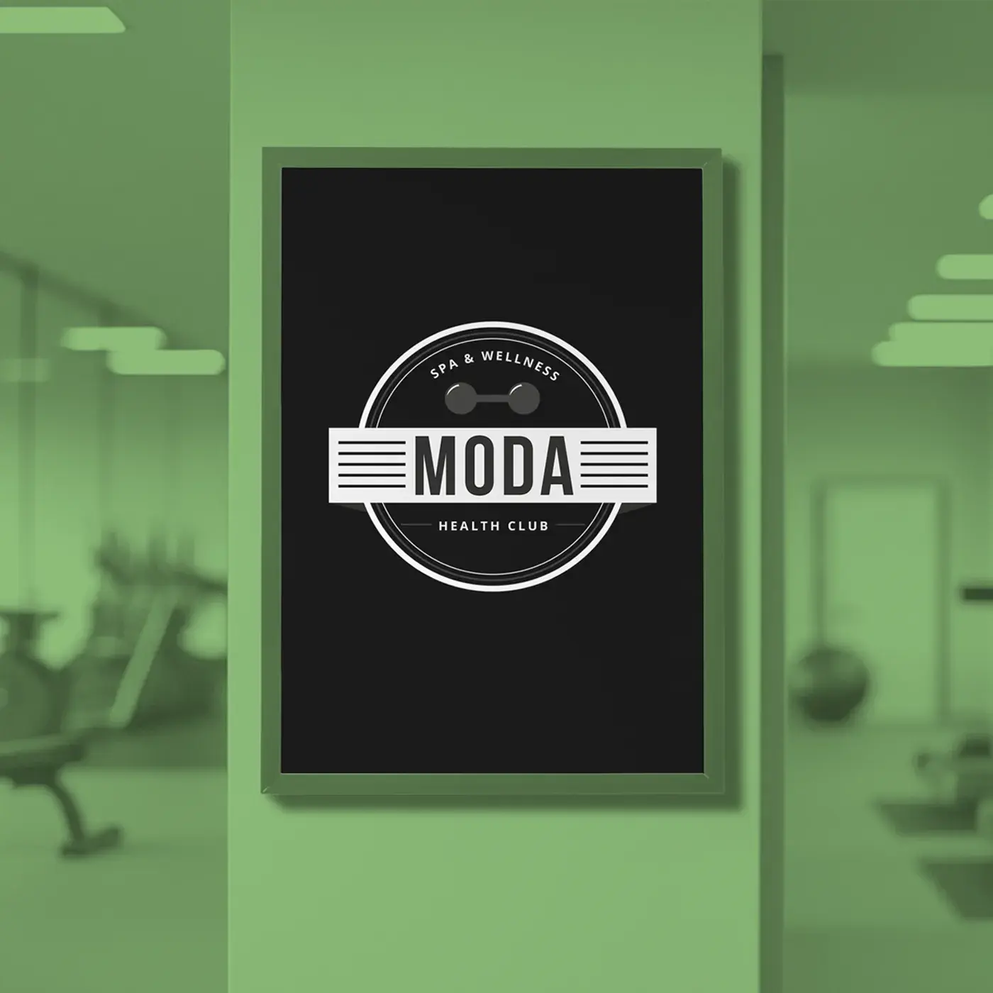 A framed A3 Poster on a green wall features a circular logo that reads "MODA Spa & Wellness Health Club" with a barbell icon.