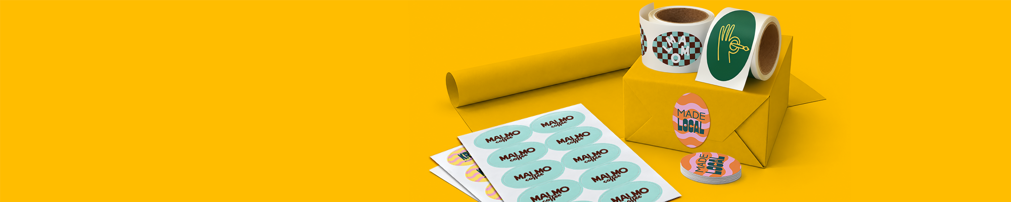 A selection of custom printed sticker sheets, sticker rolls, and a stack of oval labels set alongside a yellow wrapped parcel against a bright yellow background.