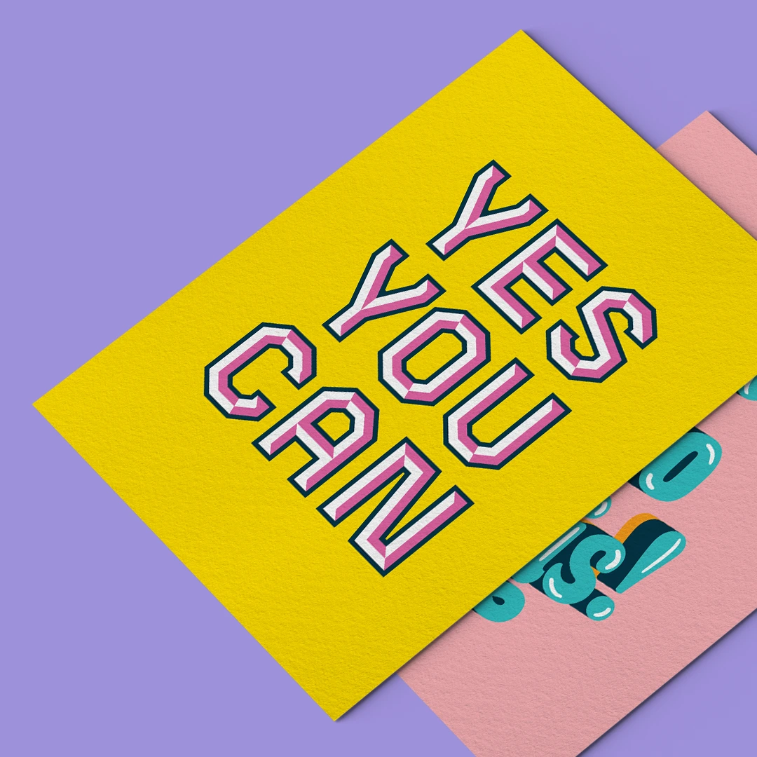 A bright yellow Postcard with pink and white text reading "YES YOU CAN" layered over a pink card.