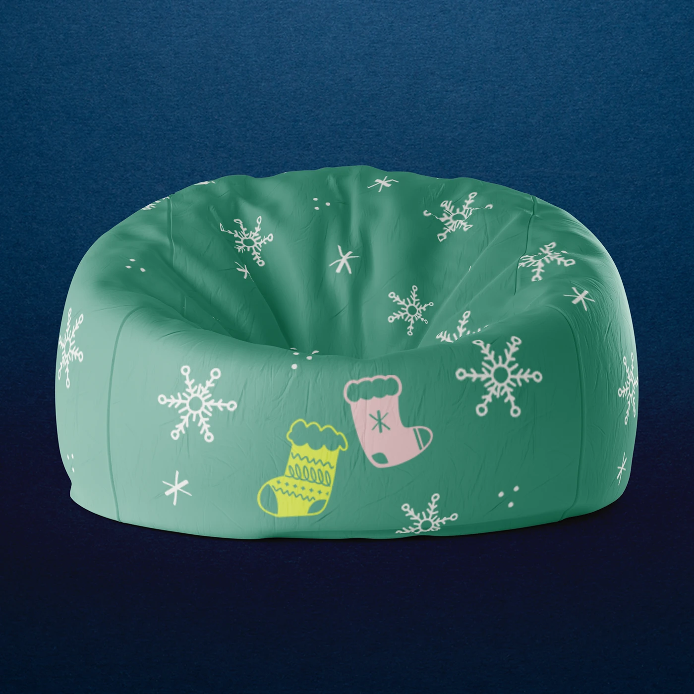 A round green Christmas Bean Bag chair pattern with white snowflakes and two festive stockings - one yellow and one pink - against a dark blue background