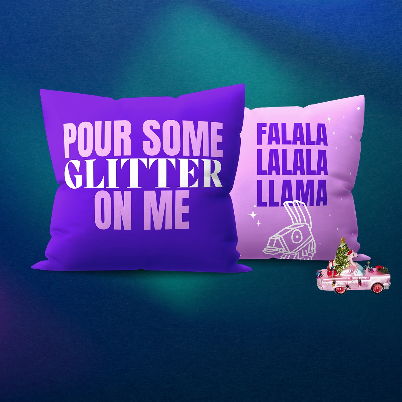Two Christmas Cushions — a dark purple Cushion reading "POUR SOME GLITTER ON ME" and a light pink with purple text reading "FALALA LALALA LLAMA" above a llama illustration - next to a miniature toy pickup truck carrying a Christmas tree.
