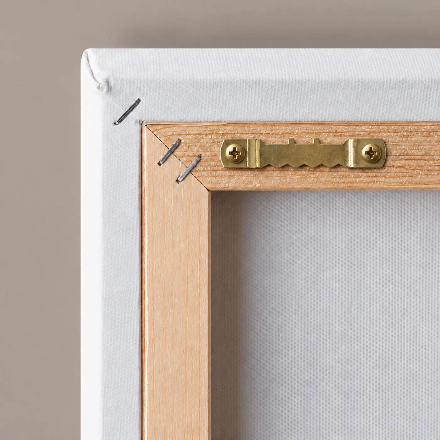 Close-up of the back of a stretched Canvas Print, showing the wooden frame, canvas wrapping and hanging hardware for wall mounting.