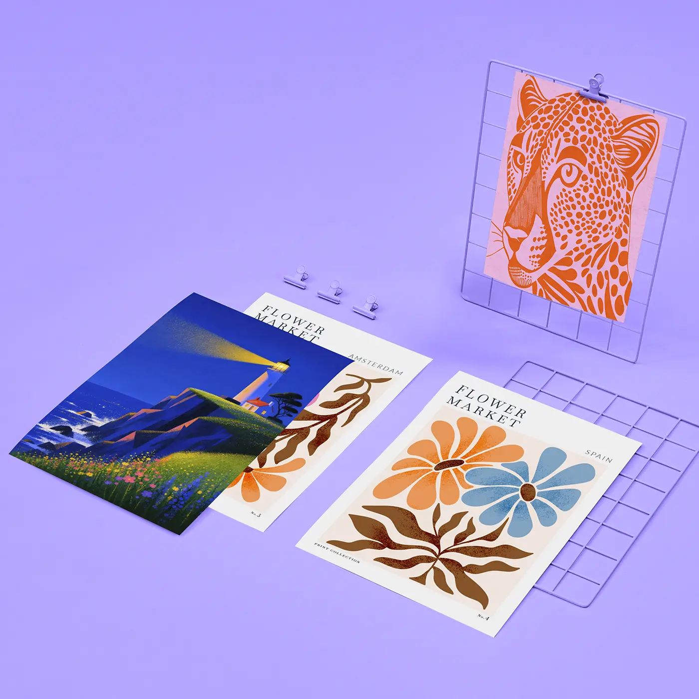 Assortment of Giclée Art Prints displayed on a pastel purple surface, showcasing colourful floral, wildlife and landscape designs in various print styles.