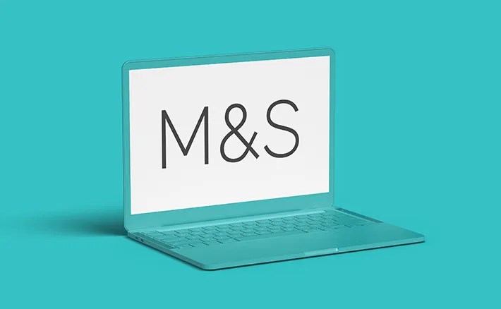 A teal laptop set against a matching teal background, displaying the Marks and Spencer (M&S) logo on its screen.
