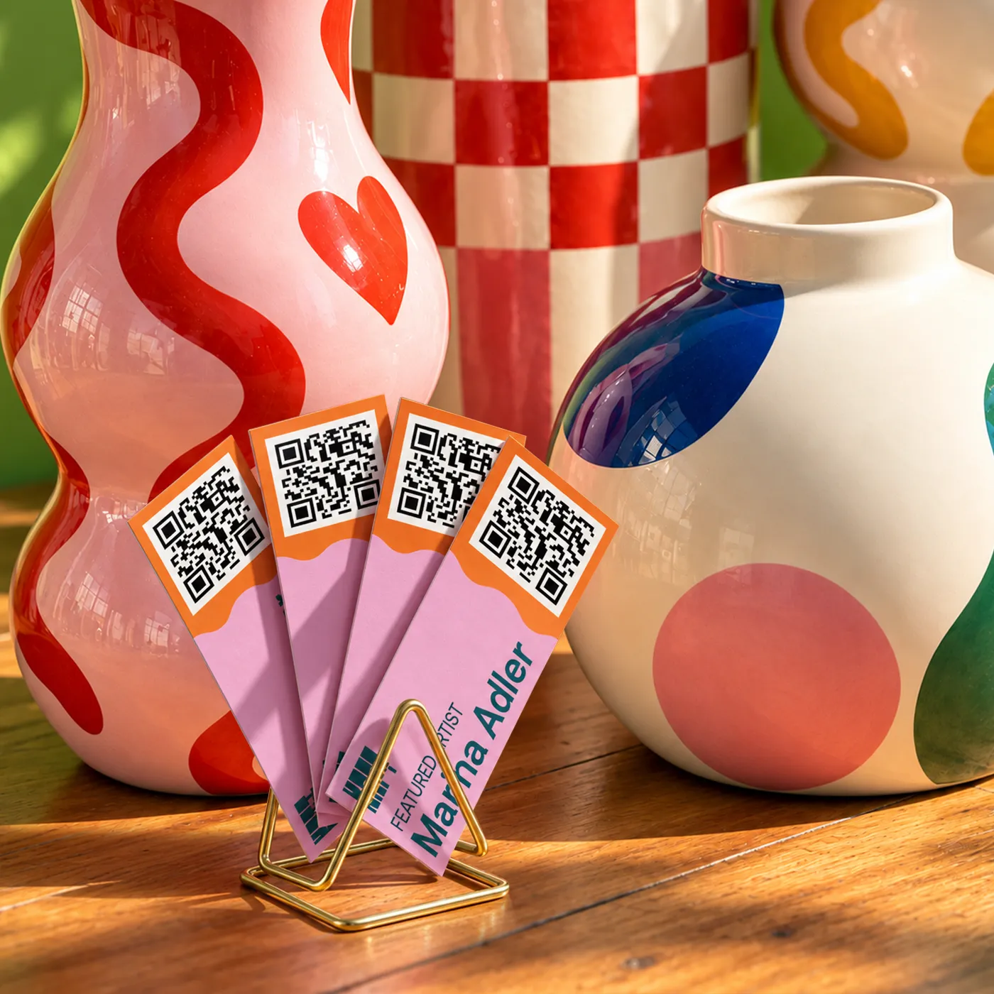 Mini Business Cards with QR codes displayed in a colourful retail-style setting alongside decorative vases.